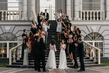 Candid shot of two female lesbian LGBT brides walking down the stairs during their wedding...