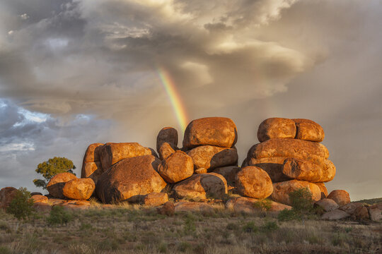 Devil's Marbles in Northern Territory and a rainbow on the background