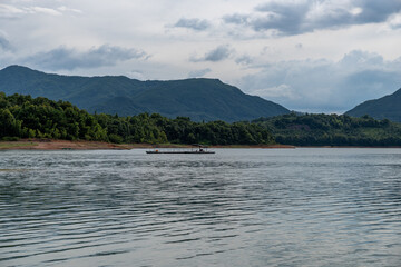 The sky is covered with clouds and there are waves on the water