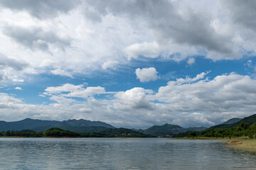 The sky is covered with clouds and there are waves on the water