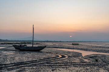 At dusk, abandoned fishing boats docked in the shoal