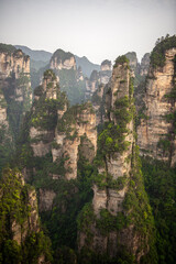 Fototapeta na wymiar Vertical image of the karst limestone rocks of Avatar mountains (name of the mountains) during the sunset in Wulingyuan national forest park, Zhangjiajie, Hunan, China. Beautiful scenery, Unesco