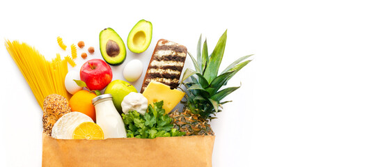 Healthy food products in a craft package. A bag of groceries. Healthy food delivery. Delivery of useful products in a croft package. Food delivery for the party. Diet food. Healthy food at home.  - obrazy, fototapety, plakaty