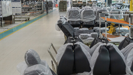 Car seats in the warehouse in the package. the car seat installation line is working.