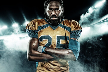 Fototapeta na wymiar American football sportsman player on stadium with lights on background
