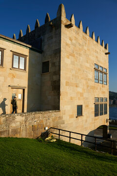 a man with a backpack approaches the wooden door of a palatial building