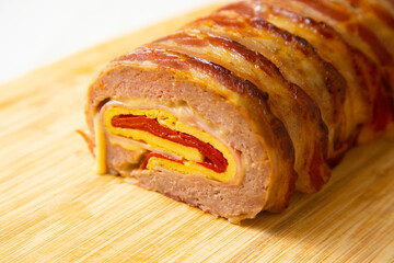 Roast beef roll stuffed with peppers, ham, cheese and omelette.