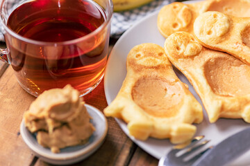 Traditional breakfast with pancakes and hot tea.