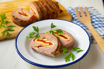 Roast beef roll stuffed with peppers, ham, cheese and omelette.