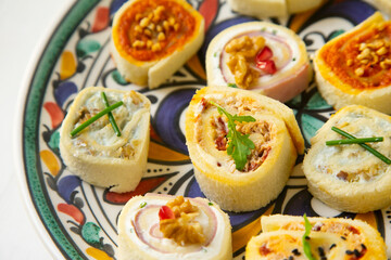 Assorted canapes on a colorful plate.