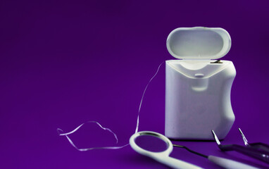 Dental instrument set, basic dental instruments isolated on purple background, side view