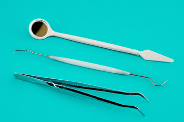 A set of dental instruments on a blue background. Minimalistic concept
