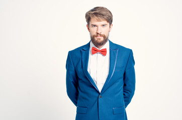 man in suit red bow tie posing