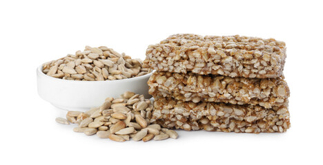 Delicious sweet kozinaki bars and sunflower seeds on white background