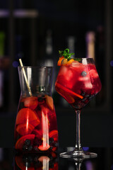 Delicious sangria cocktail on black table in bar
