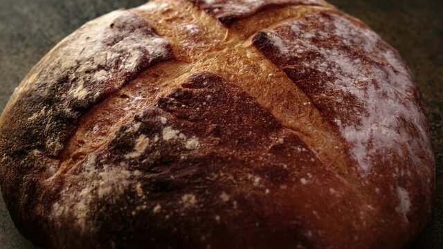 Freshly baked natural bread is on the kitchen table.