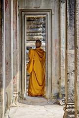 a monk with orange robe at Angkor Wat temple, Cambodia - obrazy, fototapety, plakaty