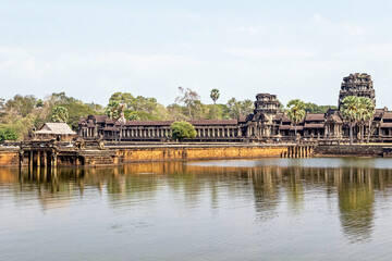 Fototapeta na wymiar old ruins of Angkor Wat temple at lakeside in Cambodia 