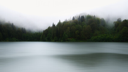 Long exposure of lake, Foggy mountain lake