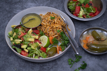 Mexican vegan bowl with  hash browns, avocado salad and avocado salsa