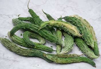 Young bitter gourd on marble white table