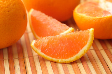 Fototapeta na wymiar close up of slice of orange fruit on color background 