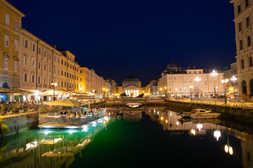 Canal Grande di Trieste at night with beautiful buildigs and refletion on the water