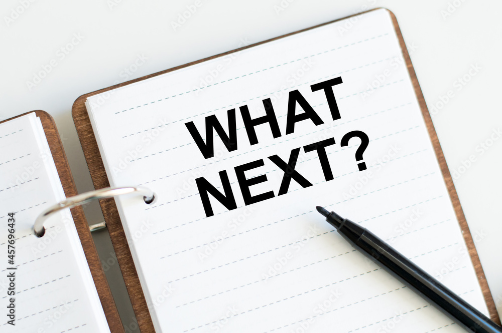 Poster what's next text on notepad beside black marker