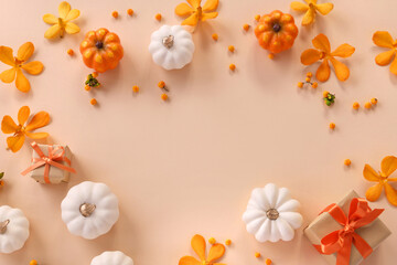 Halloween composition with pumpkins, gift boxes, orange color orchid flowers and autumn berries. top view flat lay. ハロウィン背景　パステルカラー　お花とかぼちゃ