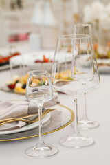 Wedding Setup . Wedding decor. Banquet. The chairs and round table for guests, served with cutlery, flowers and crockery