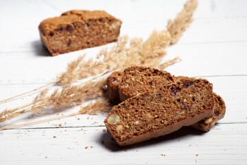Gluten-free homemade bread on a light wooden background. Ears of cereals