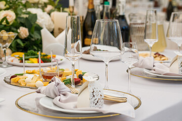 Wedding Setup . Wedding decor. Banquet. The chairs and round table for guests, served with cutlery, flowers and crockery