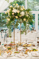 Wedding Setup . Wedding decor. Banquet. The chairs and round table for guests, served with cutlery, flowers and crockery