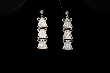 Beautiful antique silver earrings on black background