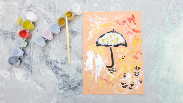 Autumnal card . Child paint umbrella and abstract autumn park use sponge and birds feather like a paintbrush, crafts for kids.