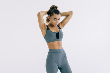 Fototapeta premium Young woman in sportswear on white background