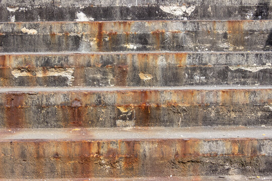 Old industrial concrete stairs with rust