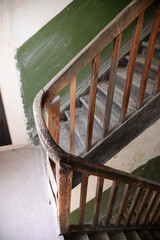Old vintage staircase with wooden railing