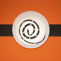 creepy snake in plate on orange background. The minimal scary and spooky concept for Halloween. Trendy horror top view idea for October party