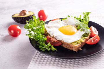 fried egg wit lettuce tomato avocado toast and peanut butter sandwich