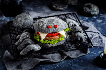 Black dough spider hamburger for halloween, holiday food concept, horizontal
