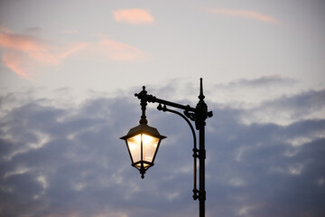 Silhouette of a city lantern against the sky