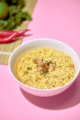 Quick noodle Soup on pink background.Quick noodle Soup on pink background.