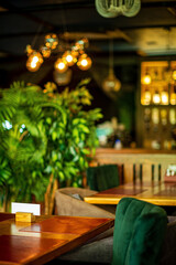 Restaurant interior with plants. Cozy atmosphere in a trendy place.