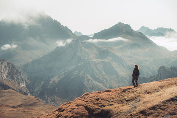 Young adventurous woman trekking in the high mountains. Lifestyle relax and freedom. The beauty of...