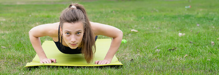 Young woman goes in for sports in the park near the house. Photo series