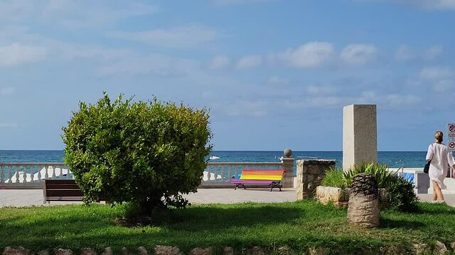 Rainbow bench on on Sitges Beach, Spain.