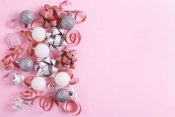 Festive Christmas decorations on pastel pink background. Flat lay, blank space.