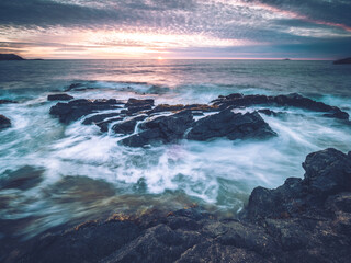 Fototapeta na wymiar Coast Scenery Sunset with waves and purple sky
