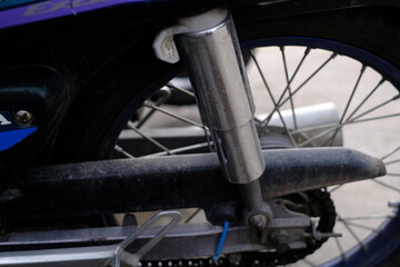 Close-up of the motorcycle rear shock cylinder.